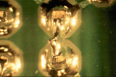 Figure 7: Poor solderability of bare tips caused these solder spikes and subsequent short Figure 7: Poor solderability of bare tips caused these solder spikes and subsequent short